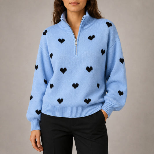 Woman wearing the Amora heart-print half-zip knit sweater in Light Blue