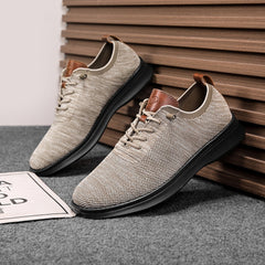 Men's breathable knit dress sneakers, cream upper with black sole, angled pair view
